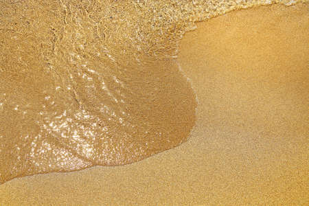 sea water on sandy beach closeup, natural daylightの写真素材