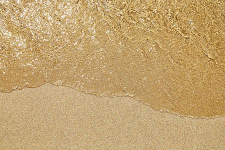 sea water on sandy beach closeup, natural daylightの写真素材