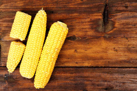 corn on old wooden surface with space
