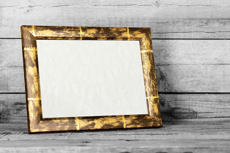 blank picture frame on woodの写真素材