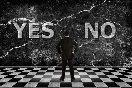 businessman trying to choose between a yes or no optionの写真素材