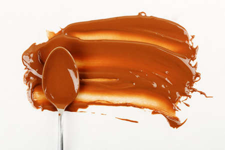 spoon with melted chocolate on baking paperの写真素材