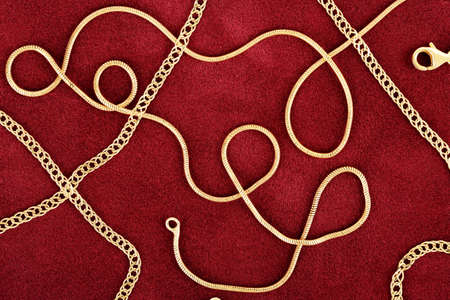 gold chains on red felt texture, abstract compositionの写真素材