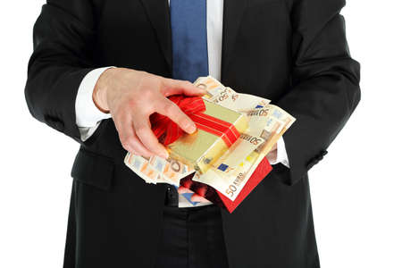 man in suit holding a gift box full of moneyの写真素材