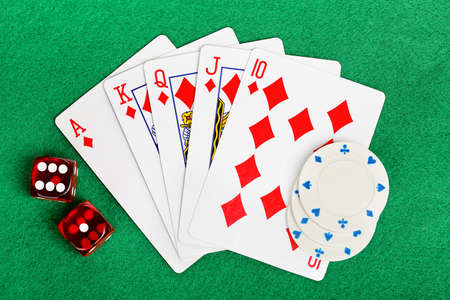 playing cards with dice and poker chips on felt