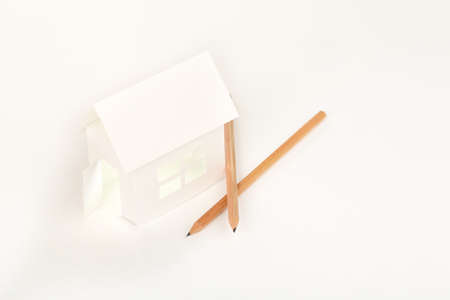white cardboard house with pencils on white, house conceptの写真素材