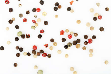 variety of peppercorns on white surface