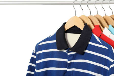 colorful polo shirts on hangers isolatedの写真素材