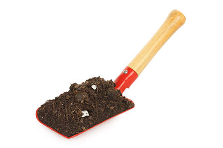 garden shovel with soil isolated on whiteの写真素材