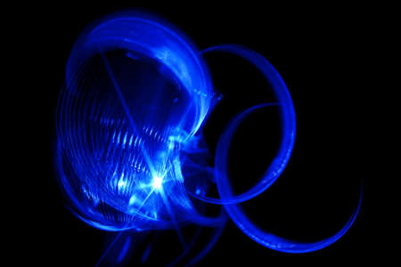 abstract blue spinning light, slow shutter speed effect or light paintingの写真素材