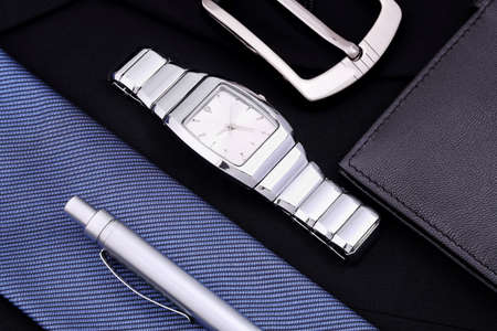 watch, pen, tie, belt and wallet on blue jacket, accessories for menの写真素材