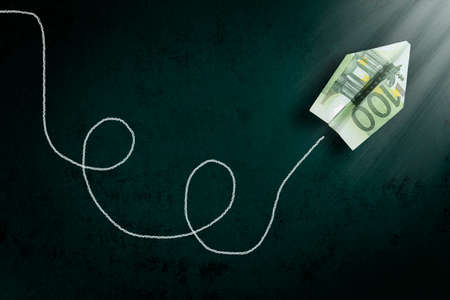 hundred euro paper plane going towards a light beam, abstract money conceptの写真素材