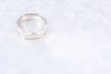 elegant silver ring with gemstones on shiny surface
