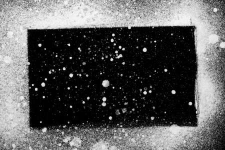 rectangular grungy background or element for designs, white spray paint on blackの写真素材