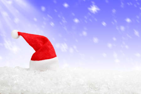 santa hat on snow against christmas background, xmas conceptの写真素材