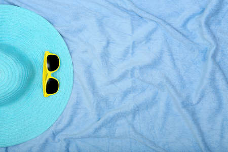 blue hat and sunglasses on beach towel with copy spaceの写真素材