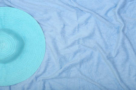blue straw hat on beach towel with copy spaceの写真素材
