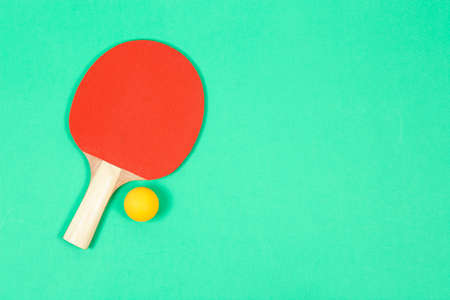 top view of ping pong racket on green surface with copy spaceの写真素材