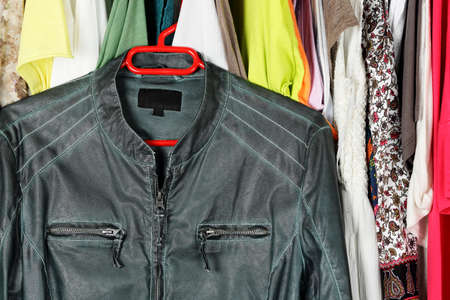 green leather jacket in front of other female clothing