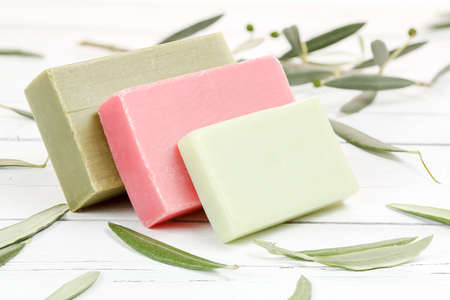 olive oil soap bars on wood with olive tree leaves の写真素材