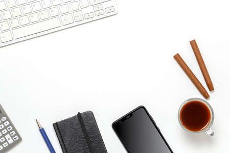 top view of white desk table with variety of items, empty space in the middle