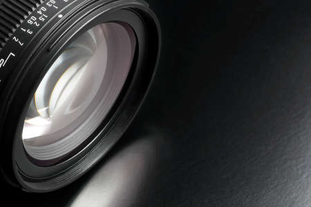 dslr camera lens on black surface
