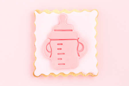 pastry with pink feeding bottle, newborn girl concept