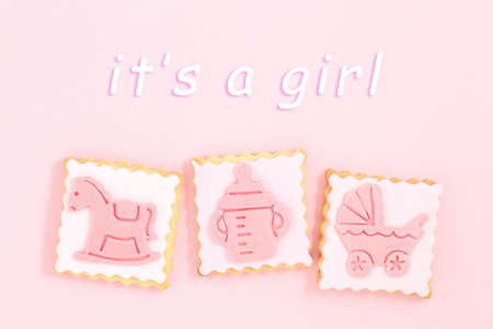 pastries with stroller, toy horse and feeding bottle on pinkの写真素材