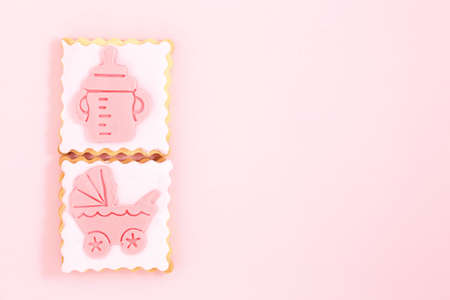 pastries with stroller and feeding bottle on pink with copy space