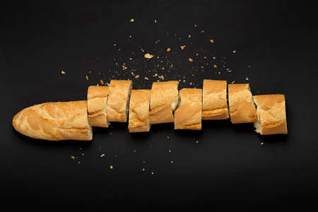 top view of sliced baguette on blackの写真素材