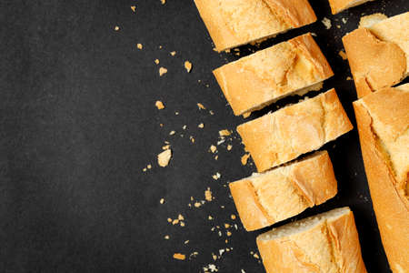 top view of sliced baguette on black with copy spaceの写真素材