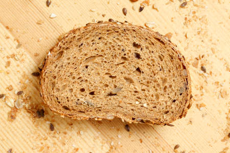 slice of multigrain bread on wooden surface