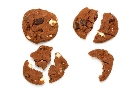 whole and broken chocolate cookies on white