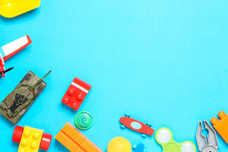 variety of toys on blue surface, top view with copy spaceの写真素材