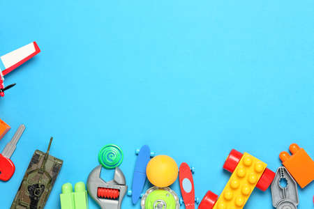 variety of toys on blue surface, top view with copy spaceの写真素材