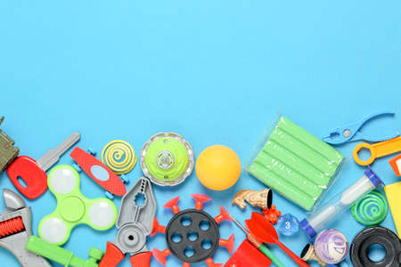 variety of toys on blue surface, top view with copy spaceの写真素材