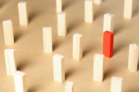 red wooden block among unpainted ones, concept for leadership or being different