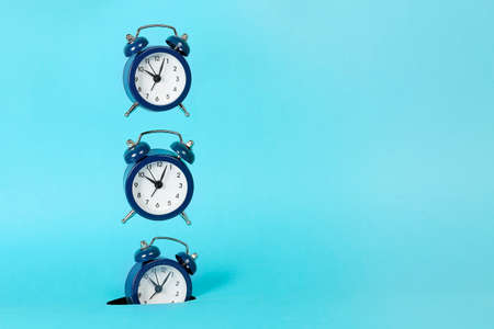 alarm clock falling into hole, abstract time conceptの写真素材