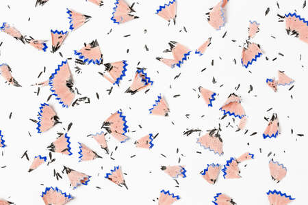 Top view of pencil shavings on white paper surfaceの写真素材