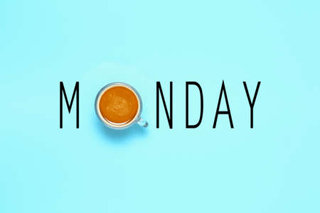 monday word on blue surface, cup of coffee as letter oの写真素材