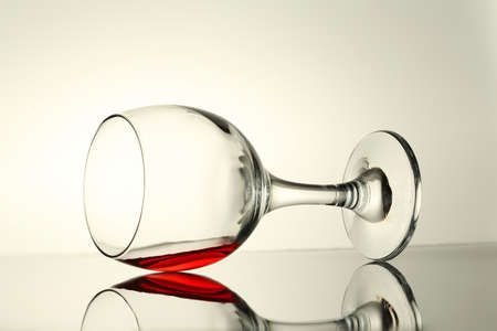 backlit image of a glass of red wine with reflectionの写真素材