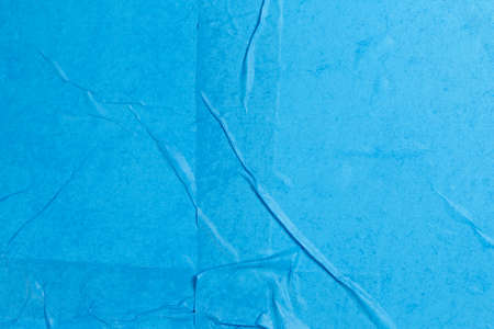 wet and wrinkled blue paper as background