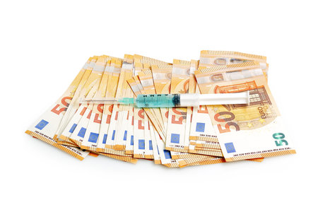 syringe on euro banknotes, concept for the cost of healthcareの写真素材