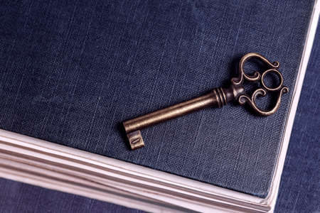 retro key on old blue book with copy space, education conceptの写真素材