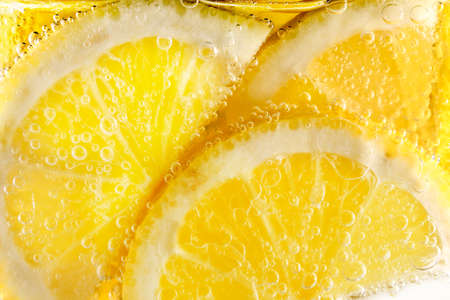 slices of lemon in fizzy mineral waterの写真素材