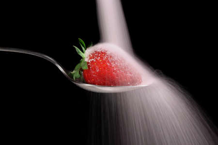 pouring sugar on strawberry, slow shutter speedの写真素材