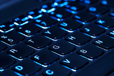 closeup of modern laptop keyboard with illuminated keys