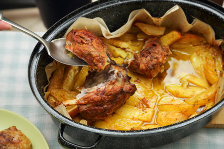 cooked pork meat with potatoes in cooking potの写真素材