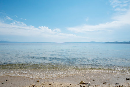 beautiful calm blue sea with clouds in skyの写真素材
