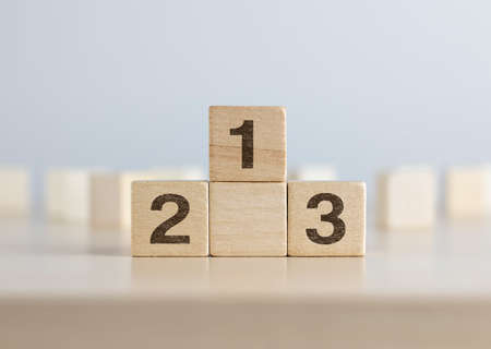 Wooden blocks stacking as a podium on white background. Success, win, winner, victory or top ranking concept.の写真素材
